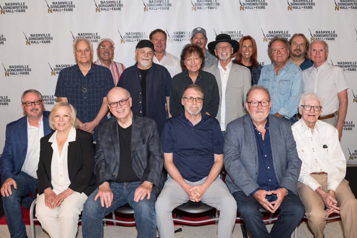 NaSHOF executive director Mark Ford, HOF member Sharon Vaughn, class of 2025 inductees Don Cook, Tony Martin and Steve Bogard and HOF member Jerry Foster. Back row (l-r) are: Wayne Kirkpatrick, Marcus Hummon, Gary Nicholson, Tim Nichols, Even Stevens, Kix Brooks, Larry Gatlin, Victoria Shaw, Tony Arata, Gary Burr and Rich Hallworth, chair of the organization's board of directors; Photo by Andrew Wendowski